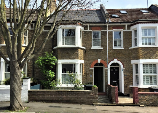A three-story residential house with 3 bedrooms, visible gardens, and a brick exterior.