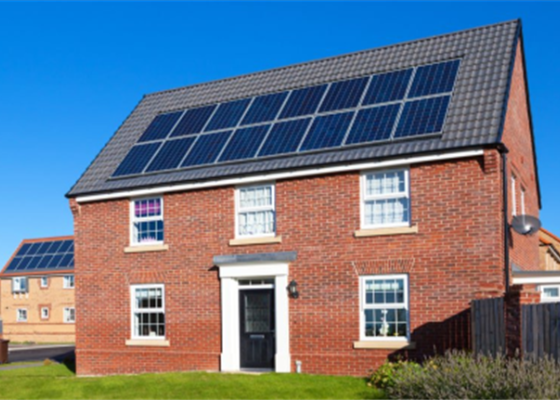 A house with solar panels installed on the roof, likely a residential property with 4+ bedrooms.